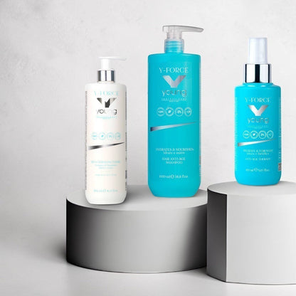 John Hair Y-Force anti-age hair care set including shampoo, conditioner, and spray on white pedestals.